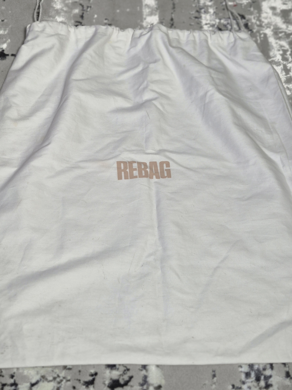 Authentic white cotton drawstring Dust bag from the luxury resale platform REBAG